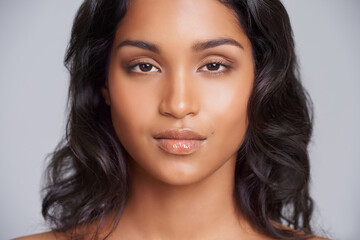 Naklejka premium Portrait, face and Mexican woman with closeup for beauty, cosmetics and makeup serious isolated on studio background. Female person, gen z girl and lady with skin for care, dermatology and treatment