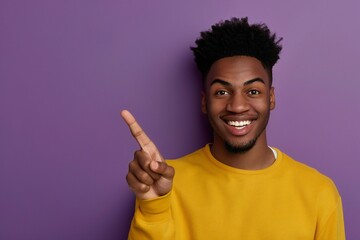 African american male person with toothy smile on face pointing with index finger on empty space...