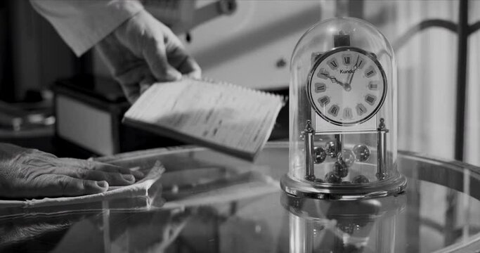 Vintage Retro tradesman in a smock: Cleaning the counter, vintage clock, 1950