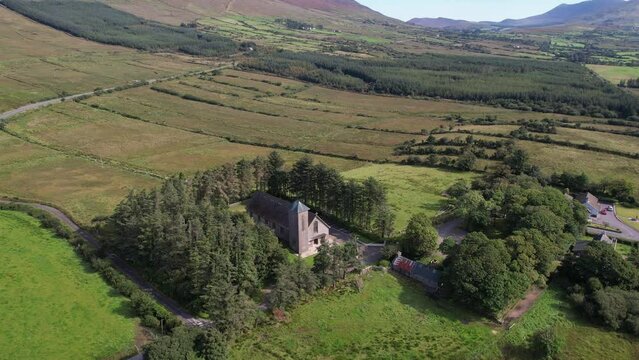 Drone video of Foilmore Church in Kerry Ireland surrounding by trees and mountains