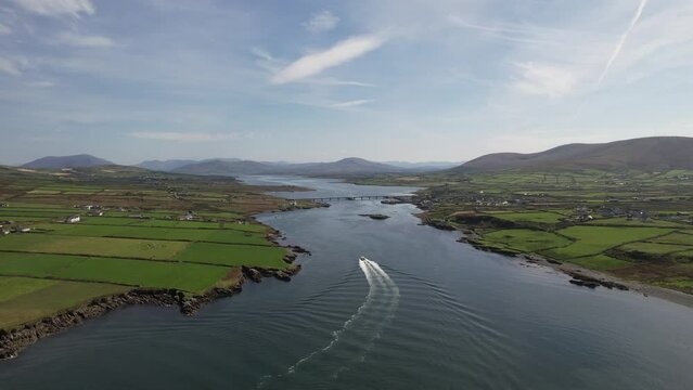 Drone video showing a boat sailing towards the town of PortMagee in Kerry Ireland