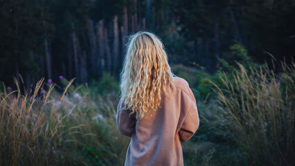 Young Blonde Girl Walking in Dark Forest - 768611376