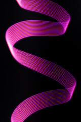 Pink and purple neon glowing wave of light with dotted stripes on black background, vertical. Abstract background with motion light effect, light painting in disco party style.