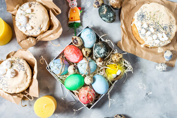 Easter egg and cake on grey concrete table. Happy easter backdrop for spring holiday. top view