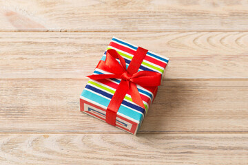 Wrapped christmas or other holiday handmade present in paper with colored ribbon. Present box,...