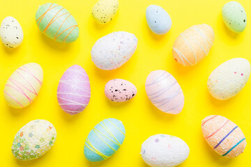 decorative easter eggs on colored background. easter eggs collection top view with copy space