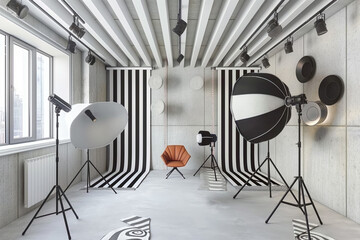 A studio with a black and white striped backdrop and a chair in the middle