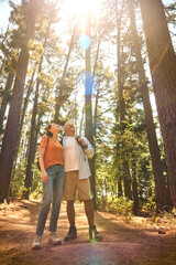 Loving Senior Retired Couple Hugging Hiking Along Trail In Countryside - 768623579