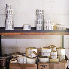 Labels, boxes or shelves in packaging, distribution or logistics business at warehouse building. Paper, stickers or rack in delivery, room or shipping as store, supply chain or industrial storage