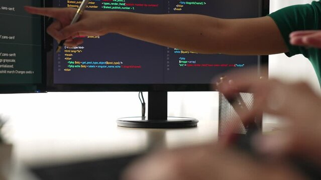 Closeup hand of back end software developer engineer for computer programming working together on debugging writing computing code, solving complex algorithms display on monitor. Burgeoning