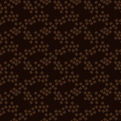 The pattern is an abstract geometric shape imitation of snake skin. The broken shape of the brown spots of the figures on a dark background. Simple chaos in a seamless texture. Animal Texture