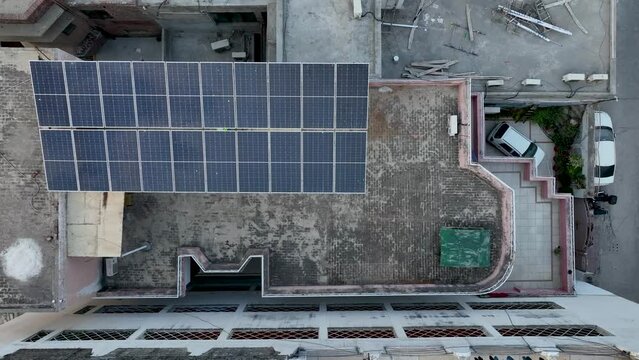 Drone flight from a building in Gujranwala with photovoltaics on the roof - Punjab