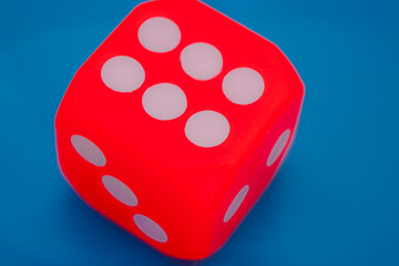 A dice showing six on blue background