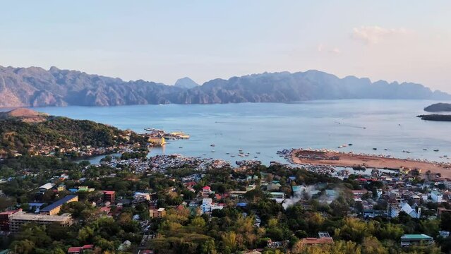 Coron city with the Coron island cliffs and the sea during sunset in the Philippines.