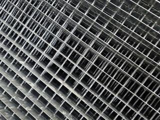 Durable metal grille. Fencing or decking material. Gray industrial back