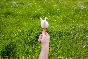 Running with easter egg in spoon. Easter rabbit
