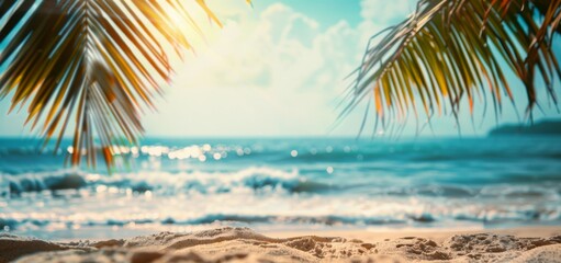 Fototapeta na wymiar Beautiful blurred background of a sandy tropical beach and sea with palm leaves on a sunny summer day