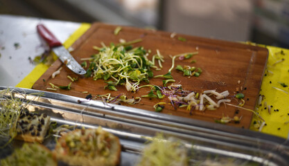 Chop the greens. Microgreens on a wooden board