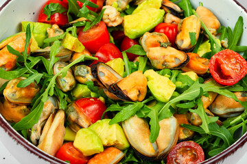 Healthy salad with mussels, herbs and vegetables.