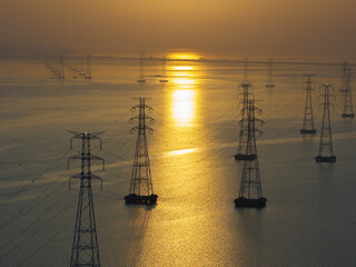 High voltage transmission tower and sunrise
