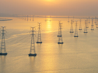 A view of the transmission tower and sunset over the sea
