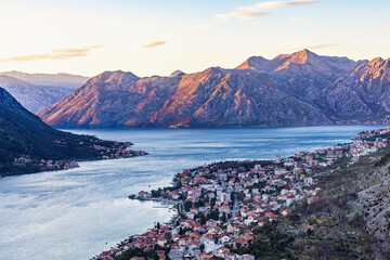 Kotor Bay at sunset. Dusk settles over bay highlighting the textured landscape and the tranquil...