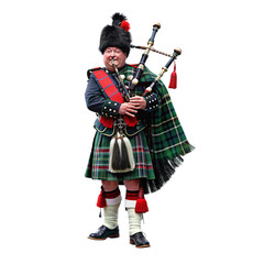 A Scotsman in full traditional dress plays the bagpipes