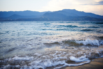 Travel, beach and water by ocean for vacation, holiday or adventure for paradise landscape. Blue sky, nature and sand by waves or sea on tropical island for outdoor weekend trip in summer on coast.