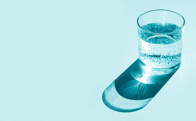 Glass of water with gas, hard shadows. Blue tint.