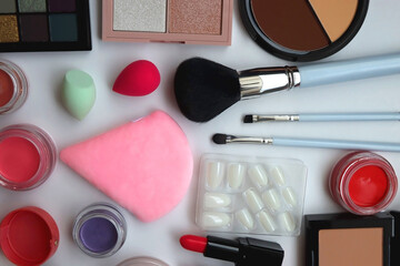 Various colorful beauty products on white background. Flat lay.