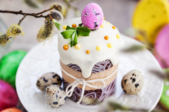 Sweet Easter bread, panettone or kulich and colorful painted eggs, Holiday spring concept