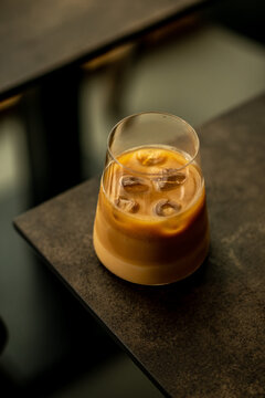 Glass of iced coffee in a minimalist coffee shop. Minimalist style.