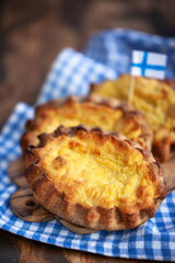 Finnish or Karelian traditional pasties (Karjalanpiirakat) - rye pies with mashed potato or rice filling - obrazy, fototapety, plakaty