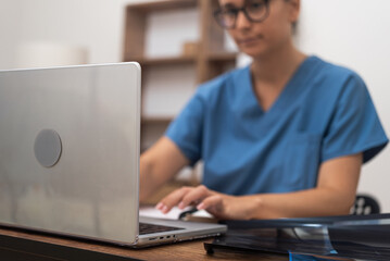 Digital Medical Consult: Engaged in online healthcare, a female doctor on her laptop showcases telehealth by offering medical assistance and conducting video conferences.