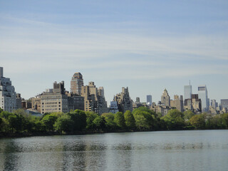Fototapeta na wymiar Central Park reservoir Upper West Side skyline blue sky Manhattan New York City USA