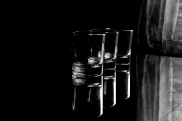 row of empty glasses made of glass isolated on black