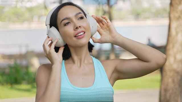 Active Woman Exercising in the Park Listening to Music