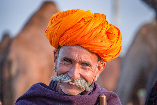 Pushkar, Rajasthan, India - November 15, 2018 Portrait of a Rajasthani Indian man dressed in traditional attire with turban (Pagadi) on his head at Pushkar camel Fair (Pushkar Mela)