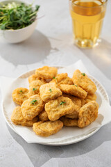 Fast food chicken nuggets paired with a glass of apple juice