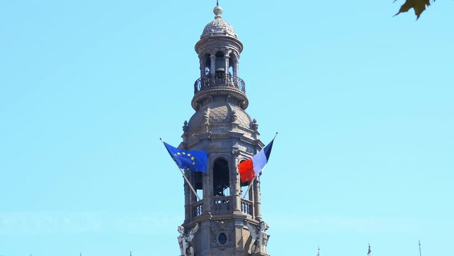 French and european flags on the belfry of the Hotel de Ville, the city hall of Paris, France