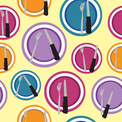 Purple, orange, blue, and pink plates composition with cutlery on an light yellow background
