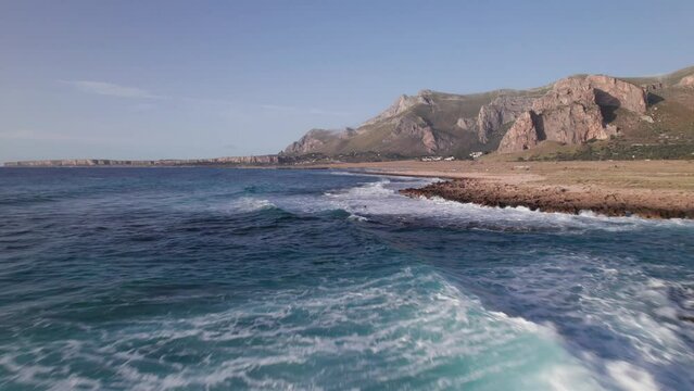 Aerial view drone of sea cost. Flying close to the sea surrounded by mountains