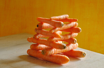 stack of carrots with beautiful lighting, healthy eating, dieting,springtime vegetable concept, free copy space - 768707544