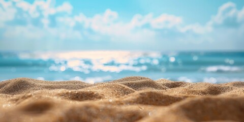 Fototapeta na wymiar A photo of an empty sandy beach with the ocean in the background, blue sky, blurred bokeh effect, closeup shot.