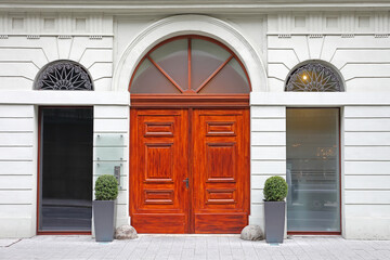 Double Wooden Arch Doors Entrance With Two Tall Windows