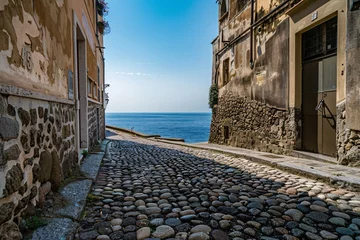 Gardinen a stone road between buildings with water in the background © Georgeta
