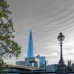 London Skyline with bridge over the river thames and a stiking grey sky