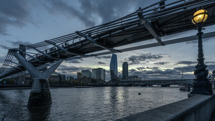 Milenium Bridge London Skyline at sundown with river Thames 