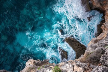 Aerial View of Turquoise Sea Clashing Against Rugged Cliffs