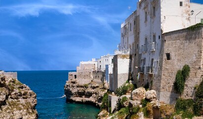 Fototapeta na wymiar Polignano a Mare, the Pearl of the Adriatic, is a seaside village of rare beauty located in Puglia, Italy. Its charm comes from its crystal clear sea, cliffs, sea caves and a beautiful historic centre